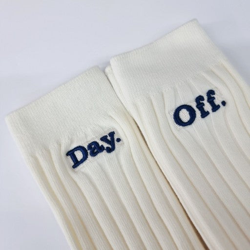 a pair of white socks with the words day off written on them