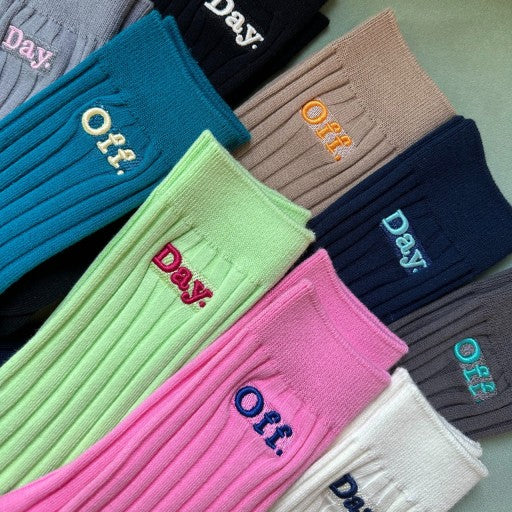 a group of different colored socks sitting on top of a table