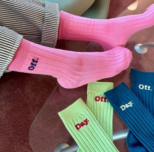three pairs of socks sitting on top of a glass table